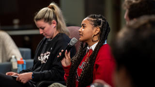 Saint Joseph's University student talking into a microphone at Day of Dialogue.