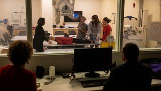 Faculty members observing medical students in Saint Joseph's Simulation Center