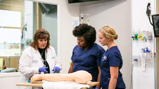 Faculty member teaching medical students at Saint Joseph's University's Simulation Center