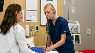 Medical students providing care to a manikin
