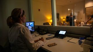 Faculty member observing medical students in Saint Joseph's Simulation Center