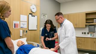 Faculty member teaching medical students in Saint Joseph's Simulation Center