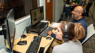 PCOM tech professionals outside of simulation lab