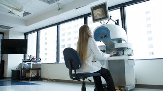 Female PCOM facilitator using camera technology