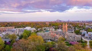 Aerial sunset view of Mandeville Hall with the Philadelphia skyline in the background