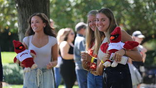 Women holding stuffed hawk