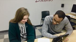 View of  tutor and student at a desk in the Writing Center reviewing the student's paper