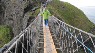 students and faculty cross a footbridge in Northern Ireland