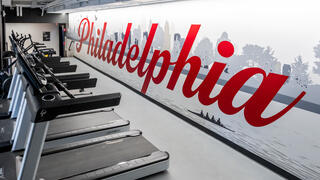 O’Pake Fitness and Recreation Center workout equipment with Philadelphia painted on the wall