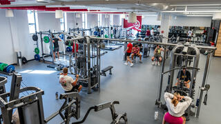 O’Pake Fitness and Recreation Center interior photo of workout equipment with people.