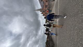 The backs of students walking through city streets.