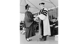 1993: Nicholas S. Rashford, S.J., awarding diploma to graduate.