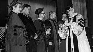 1990: Nicholas S. Rashford, S.J., presenting the Bene Merenti medals to several faculty members, including Catherine S. Murray, Thomas J. Donahue, and others.