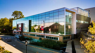 A mirrored modern building, the IPEX, at SJU's University City location