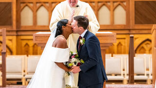 Couple kissing in wedding ceremony