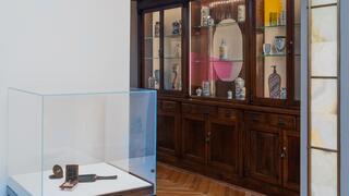 Gallery installation view with ceramics in cases. 