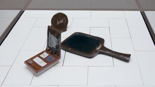 Detail of sculptures in the shape of cosmetic compacts.