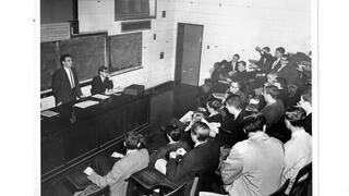 students listening to lecture in an amphitheater