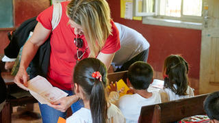 woman showing a child a document