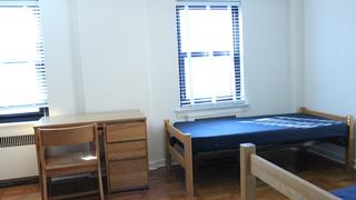 a bedroom inside merion gardens apartments in philadephia, pa