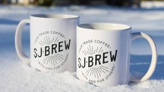 Two coffee mugs sitting in the snow