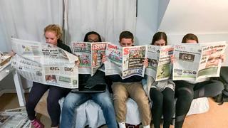 saint joseph's university students reading newspapers during summer program in south africa