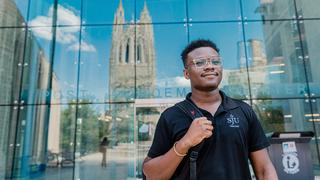 Undergraduate student walking out of Post Learning Commons on Saint Joseph's Campus
