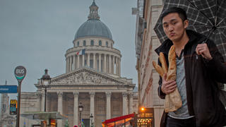 male student holding a bag of french baguettes outside