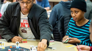 Students playing a board game