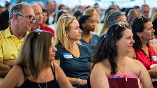 Parents listen to a speaker during orientation 