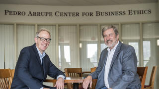 Associate Director David Steingard, Ph.D., and McShain Chair in Ethics John McCall, Ph.D., sit in front of the Arrupe Center