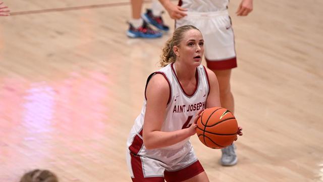 Women's basketball player Laura Ziegler in position to shoot a basket