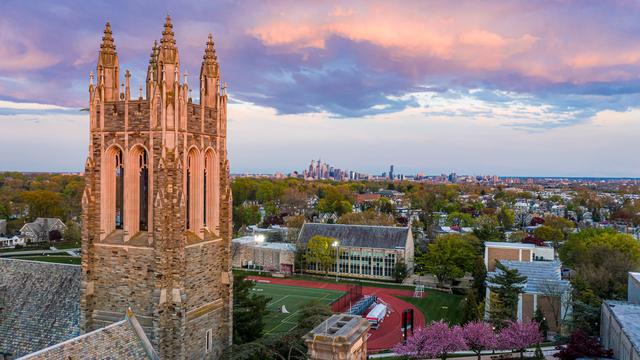SJU campus at sunset with the Philadelphia skyline in the background.