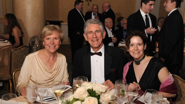 Three alumni seated for dinner at the University's Alumni Gala