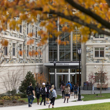 A group of students walking into a Hall.