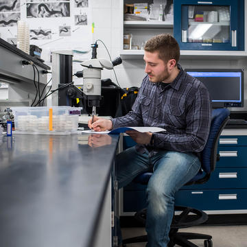 male graduate biology student at Saint Joseph's biology lab