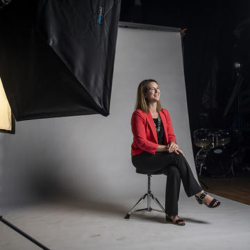 Angela Rowe McDonald sits in studio at a Marketing photoshoot.