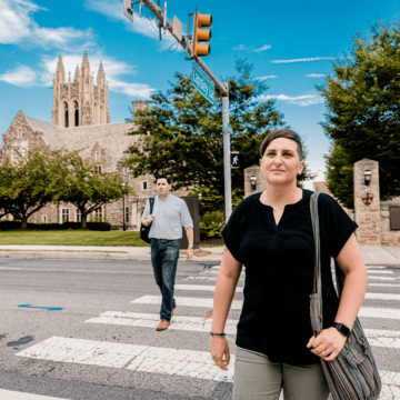 Graduate students walk across City Avenue at Saint Joseph's