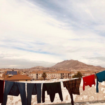 Clothes hanging on a clothesline in the middle of an empty field