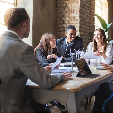 Group of business employees in a team meeting around the table in an office