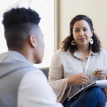 Mental health counselor speaking with client