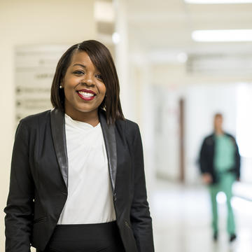 Health administration professional in hospital with nurse walking behind