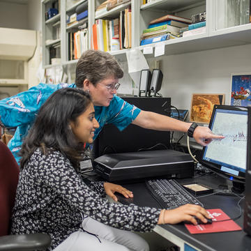 SJU Health informatics professionals looking at computer screen graph