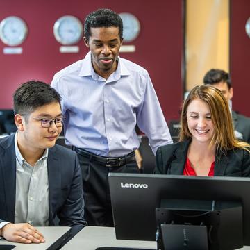 Computer science students in working on computer together