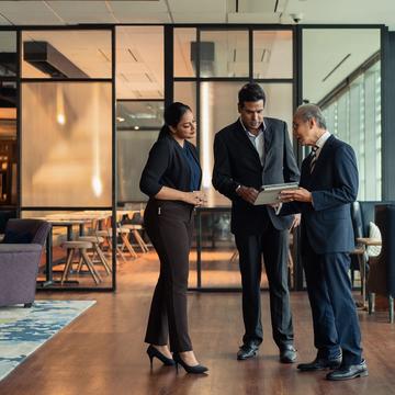 Group of individuals in business attire having a conversation.