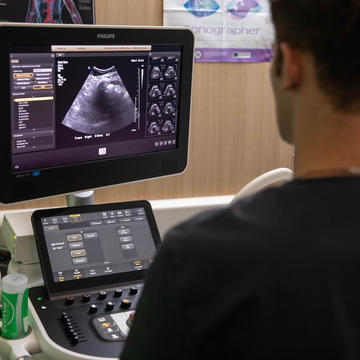 Male student looking at ultrasound images