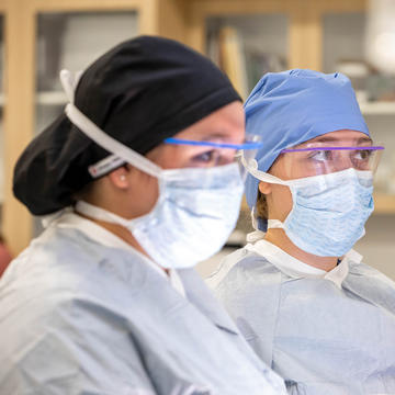 Two female nurses standing next to each other