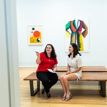 Two students studying art in a museum