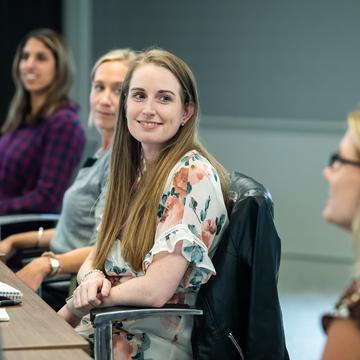 Student listening to another student in a classroom