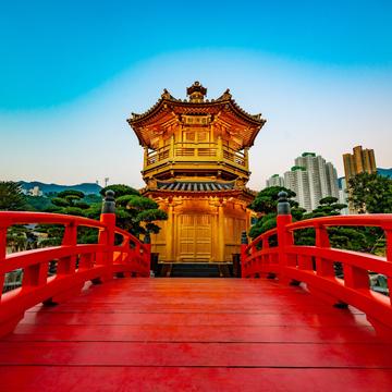 Red bridge leading to a monument building in China